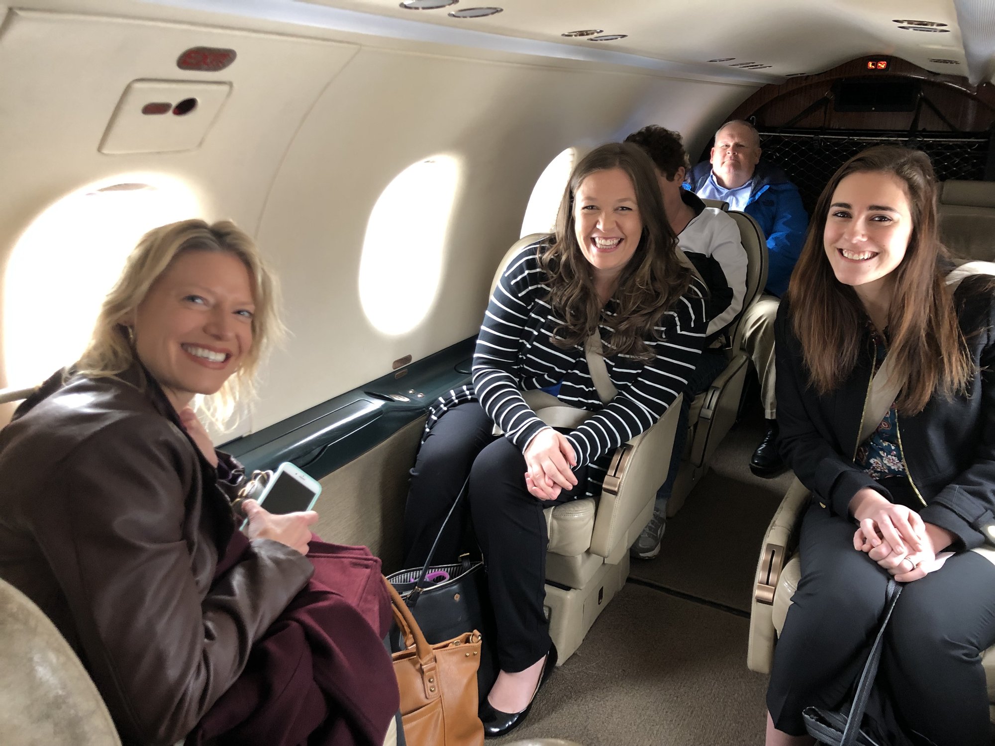 People smiling in a jet