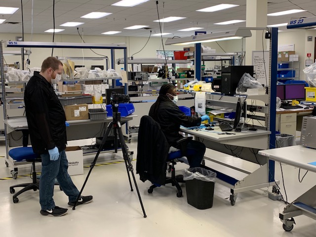 Lab tech being filmed doing work