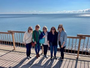 Five people stand in front of Lake Superior