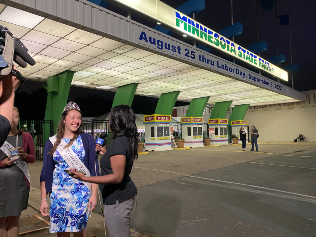 Princess Kay is interviewed by a journalist outside the MN State Fair gates