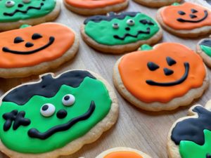 Pumpkin shaped cookies decorated for Halloween