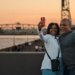 A couple takes a selfie with a beautiful Duluth sunset