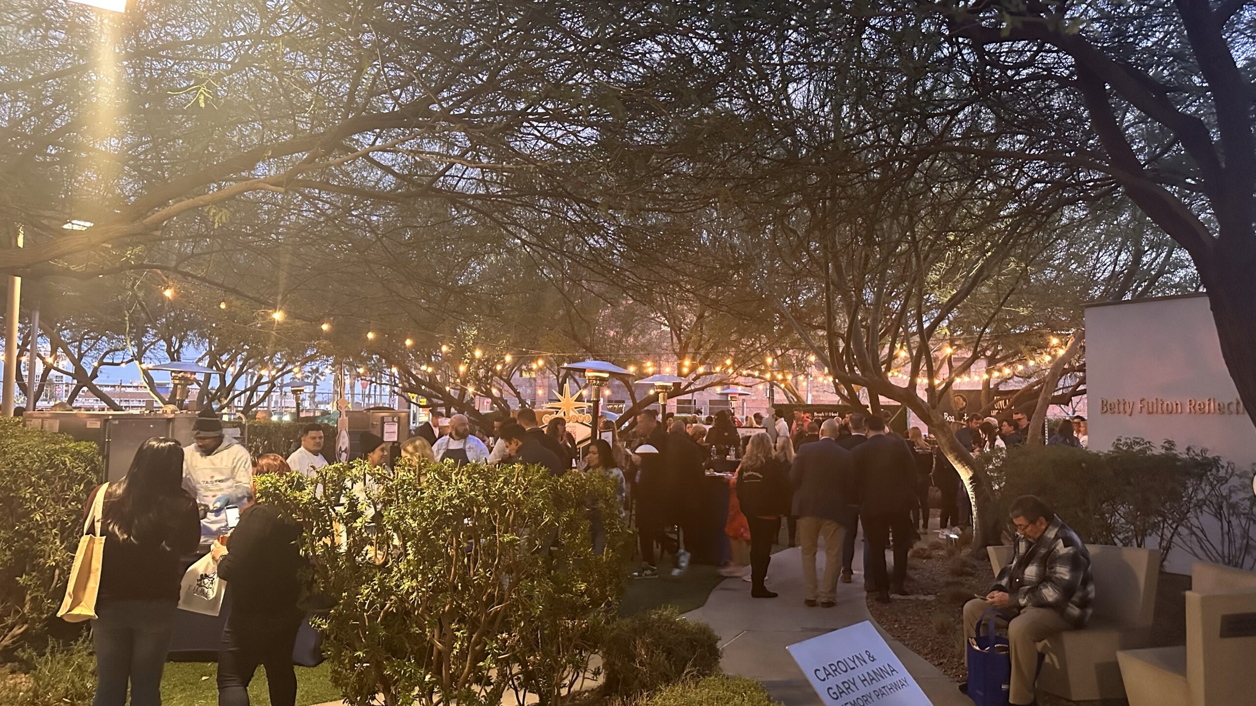 Event attendees gather on a patio for a fundraiser.