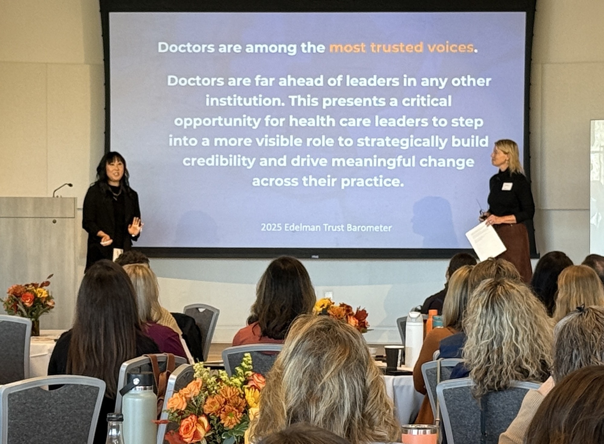 two women presenting at a conference